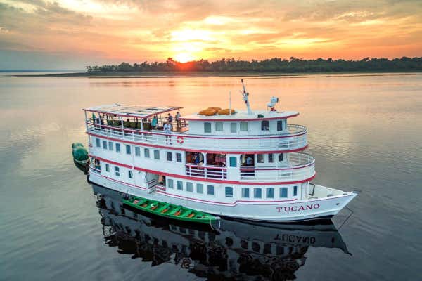 Tucano Amazon boat at sunset on the Amazon river in Brazil