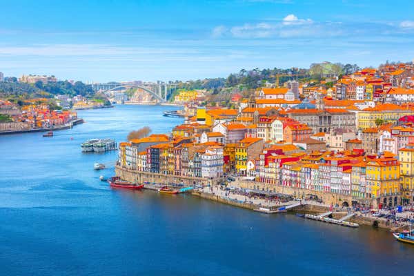 Porto, Portugal old town ribeira aerial promenade view with colorful houses, Douro river and boats