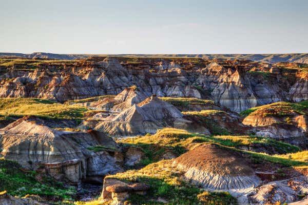 Sun setting over Dinosaur Provincial Park, a UNESCO World Heritage Site in Alberta, Canada. The Alberta badlands is well known for being one of the richest dinosaur fossil locales in the world.