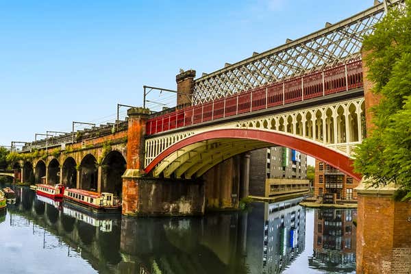 A view along a railway viaduct in the restored Victorian canal system in Castlefield, Manchester, UK