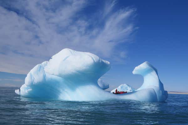 Stunning iceberg with Zodiac in distance, Spitsbergen, Arctic
