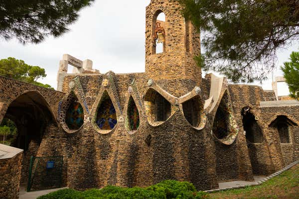 Exterior view of guell crypt, a masterpiece gaudi architecture located at catalunya outside town, Spain
