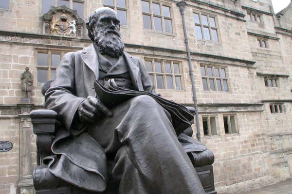 Darwin's statue and his former school which is now Shrewsbury Library, located in Shrewsbury, United Kingdom